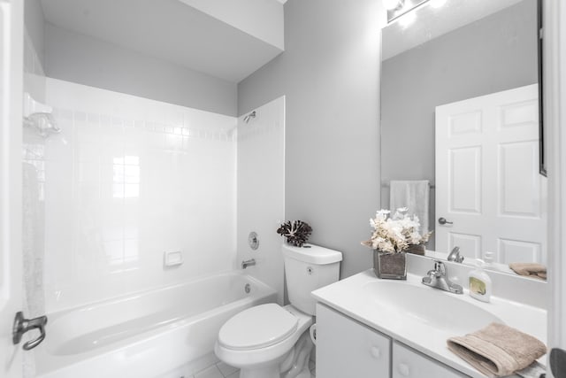 full bathroom with tile patterned floors, vanity, tiled shower / bath combo, and toilet