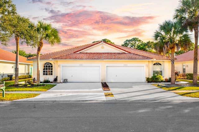 mediterranean / spanish-style house featuring a garage