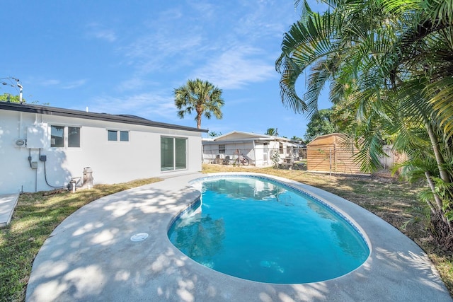 view of swimming pool with a fenced in pool and fence