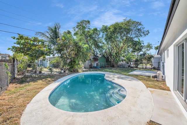 view of pool with a patio, a yard, a fenced backyard, and a fenced in pool