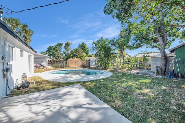 view of yard with a patio, a storage shed, a fenced backyard, and an outdoor structure