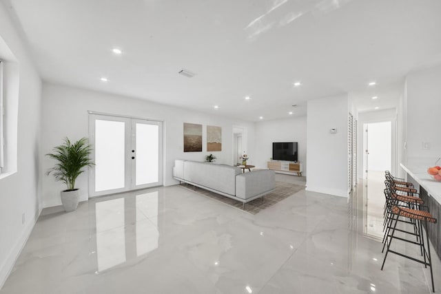 unfurnished living room with recessed lighting, french doors, and marble finish floor