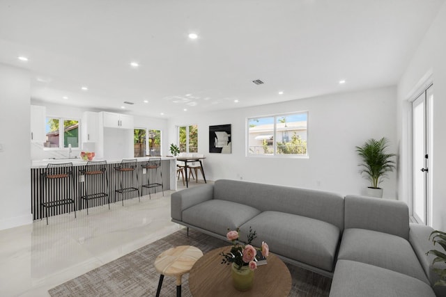 living room featuring recessed lighting and visible vents