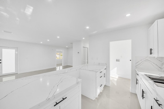 kitchen with light stone countertops, recessed lighting, decorative backsplash, white cabinets, and marble finish floor