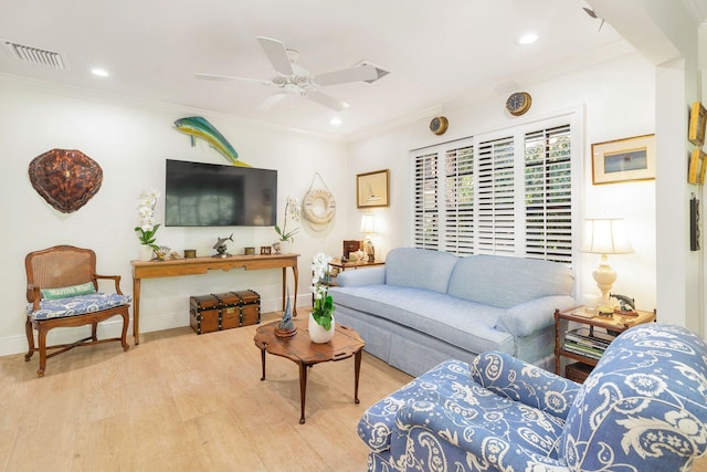 living room with crown molding, ceiling fan, and wood-type flooring