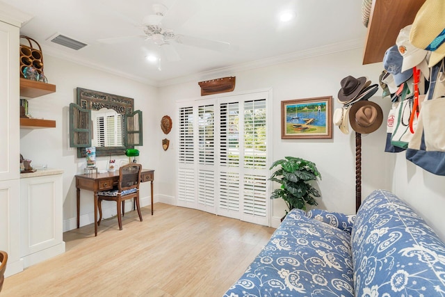 living room with light wood-type flooring, ceiling fan, and crown molding