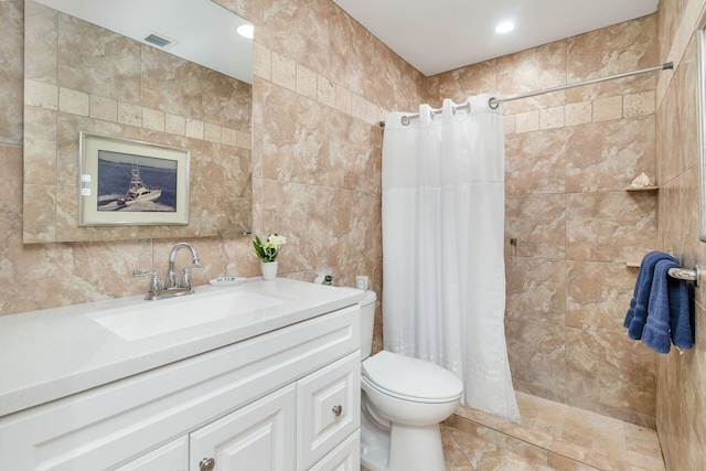 bathroom with backsplash, vanity, tile walls, toilet, and curtained shower