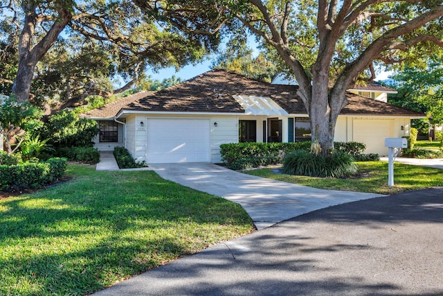 11282 Glen Oaks Ct Unit 31-C, North Palm Beach, FL 33408 - ranch-style house with a front lawn, driveway, and an attached garage