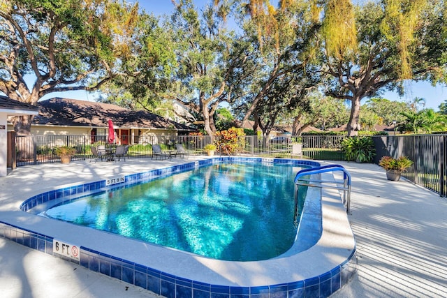 view of swimming pool with a patio