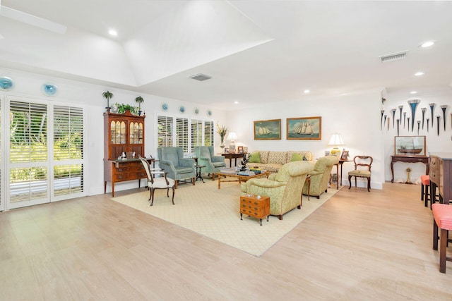 living room with ornamental molding and light wood-type flooring