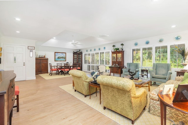 living room featuring ceiling fan and light hardwood / wood-style floors