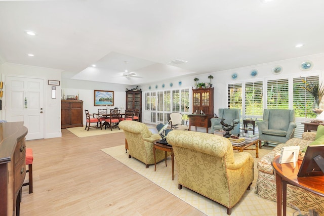 11282 Glen Oaks Ct Unit 31-C, North Palm Beach, FL 33408 - living room featuring ceiling fan, light wood-style flooring, recessed lighting, crown molding, and a raised ceiling
