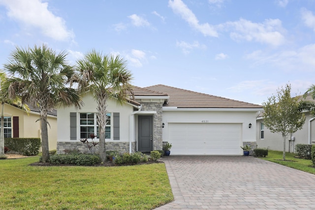 view of front of house with a garage and a front lawn