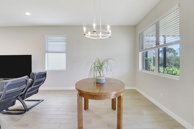 office space with light hardwood / wood-style floors and a chandelier