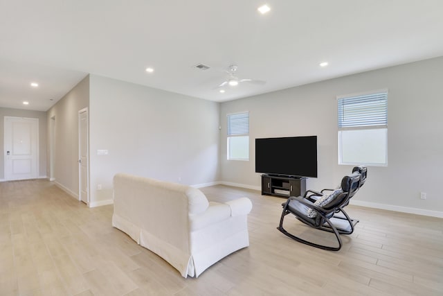 living room featuring ceiling fan and light wood-type flooring