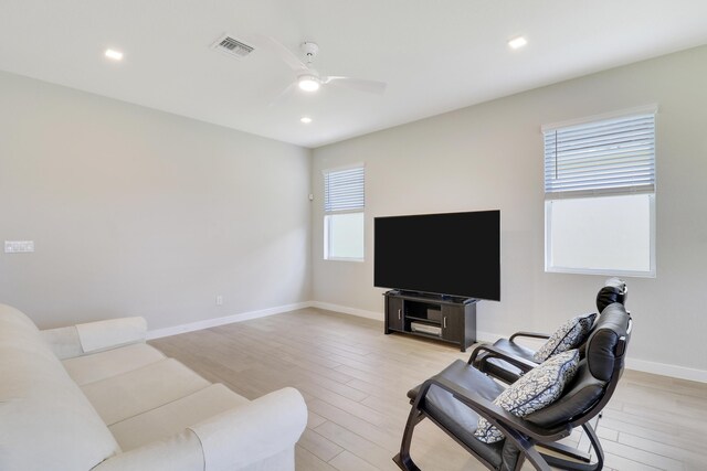 living room featuring ceiling fan, a healthy amount of sunlight, and light hardwood / wood-style floors