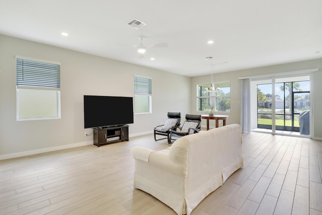 living room with ceiling fan and light hardwood / wood-style flooring