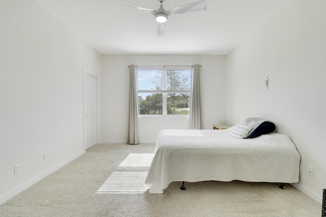 bedroom featuring ceiling fan and light colored carpet