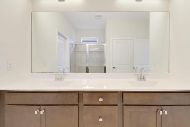 bathroom featuring vanity and an enclosed shower