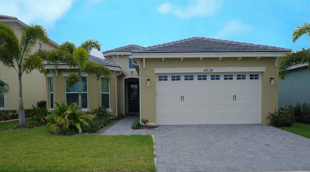 view of front of house with a front lawn and a garage