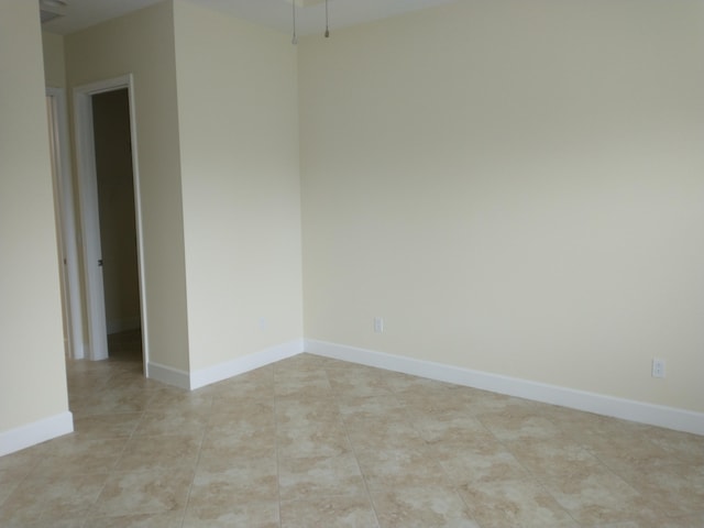 spare room featuring light tile patterned flooring