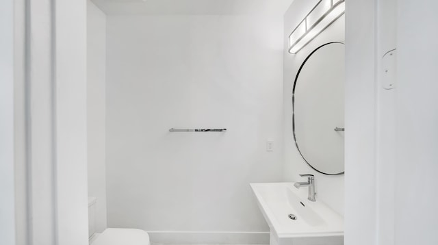 bathroom featuring sink and toilet