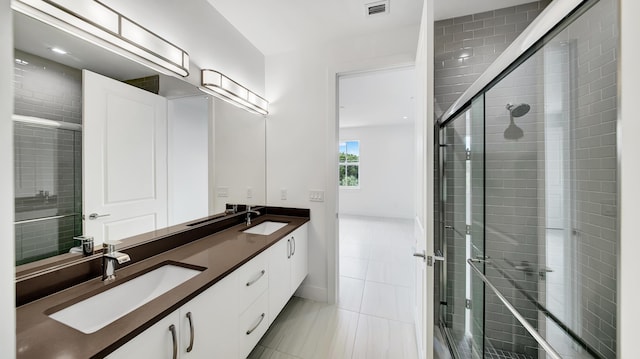 bathroom featuring vanity and an enclosed shower