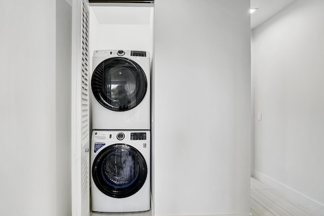 laundry area with stacked washing maching and dryer