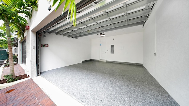 garage with electric panel and a garage door opener