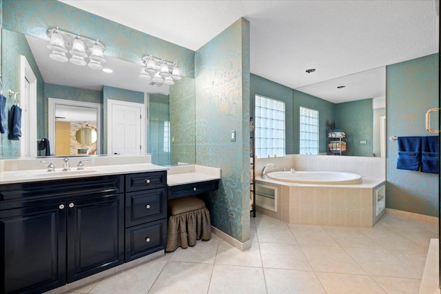 bathroom with vanity, tiled bath, and tile patterned floors