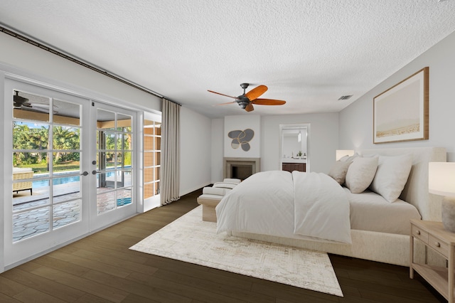 bedroom with access to exterior, ceiling fan, french doors, dark hardwood / wood-style flooring, and a textured ceiling