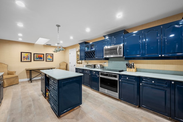 kitchen featuring blue cabinets, light hardwood / wood-style floors, decorative light fixtures, a kitchen island, and appliances with stainless steel finishes