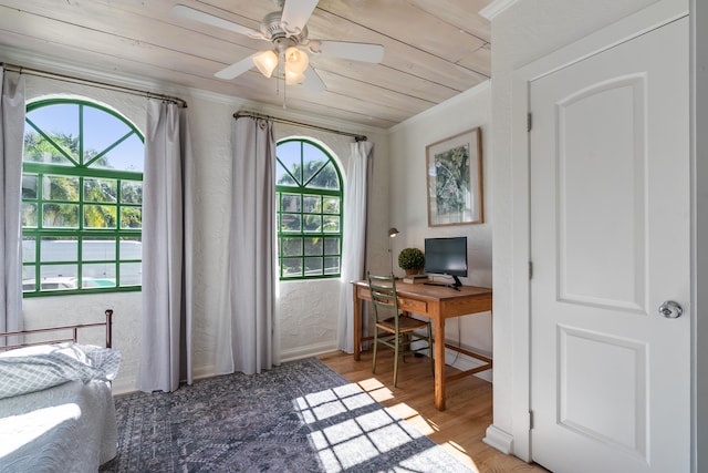 office area featuring hardwood / wood-style flooring, wood ceiling, ornamental molding, and a wealth of natural light