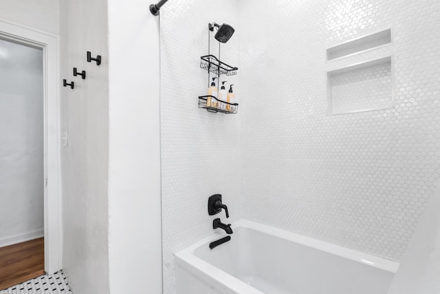 bathroom with tile patterned flooring and tiled shower / bath