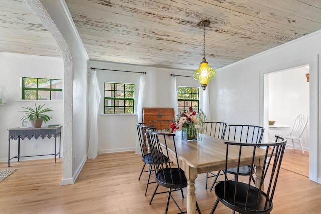 dining area featuring light hardwood / wood-style floors, crown molding, and wooden ceiling