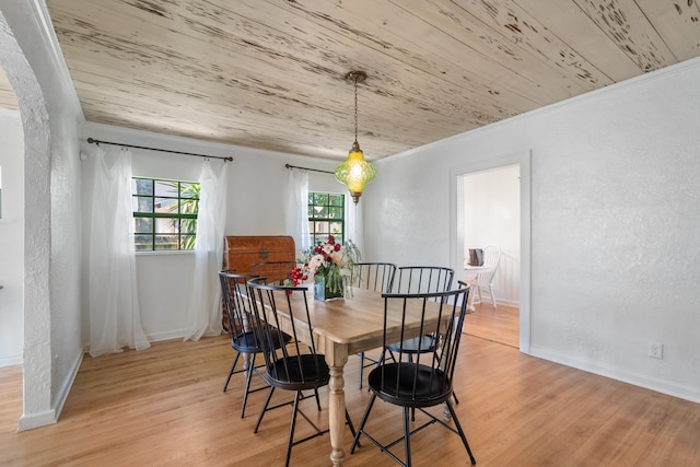 dining space with crown molding, light hardwood / wood-style flooring, and wood ceiling