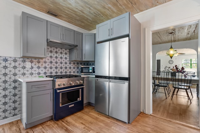 kitchen featuring gray cabinetry, ceiling fan, light hardwood / wood-style flooring, crown molding, and appliances with stainless steel finishes