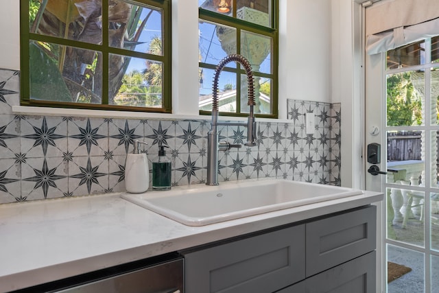 bathroom featuring a wealth of natural light and sink