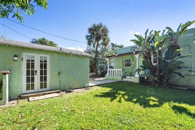 view of yard with french doors and a patio