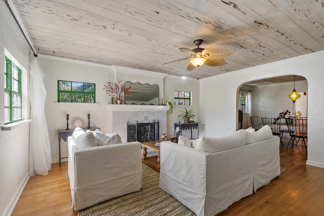 living room featuring ceiling fan, wood ceiling, crown molding, and light hardwood / wood-style flooring