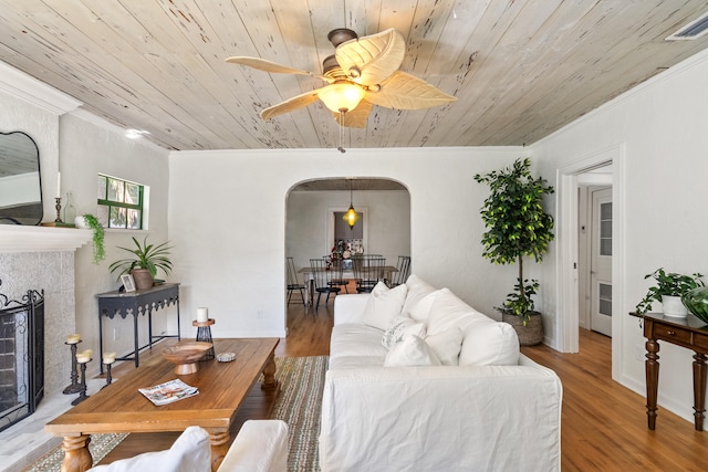 living room featuring crown molding, ceiling fan, hardwood / wood-style floors, and wood ceiling