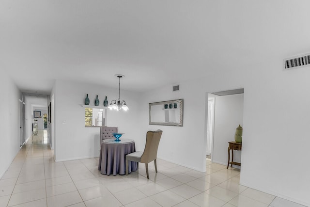 tiled dining space featuring a chandelier