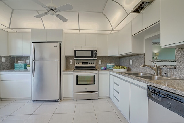 kitchen featuring white cabinets, backsplash, and stainless steel appliances