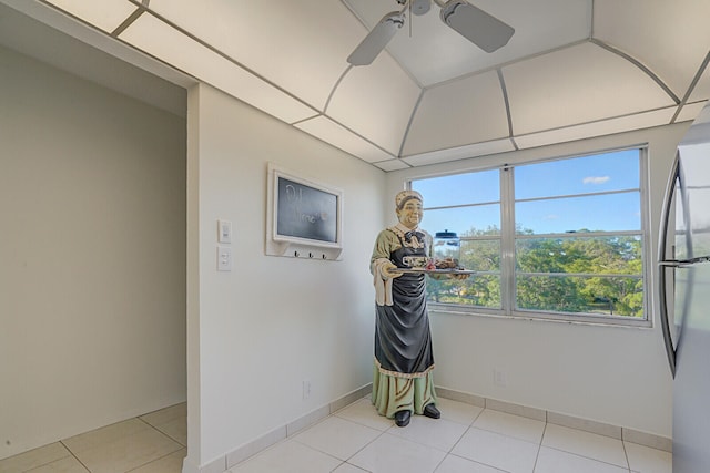 spare room featuring ceiling fan and light tile patterned floors