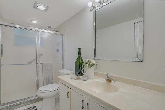 bathroom with tile patterned flooring, vanity, toilet, and a shower with shower door