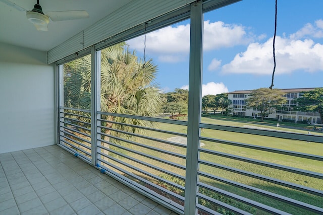 unfurnished sunroom featuring ceiling fan