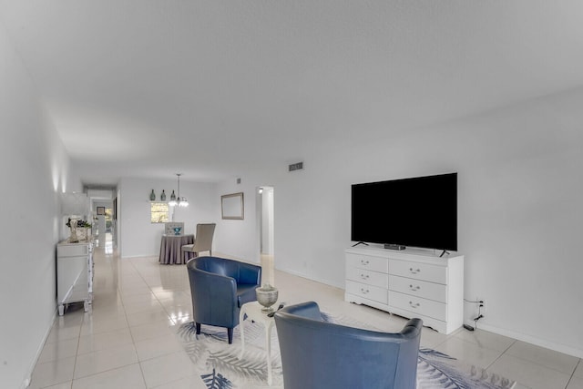 tiled living room featuring an inviting chandelier