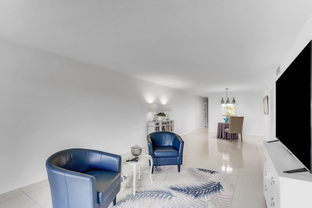 sitting room featuring a notable chandelier and light tile patterned flooring