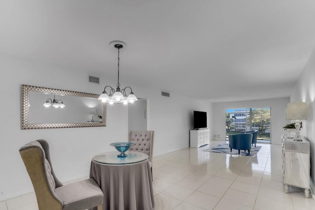 tiled dining area featuring a chandelier