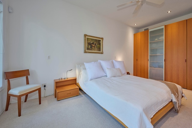 bedroom featuring ceiling fan and light colored carpet